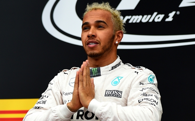 SOCHI, RUSSIA - OCTOBER 11: Lewis Hamilton of Great Britain and Mercedes GP celebrates on the podium after winning the Formula One Grand Prix of Russia at Sochi Autodrom on October 11, 2015 in Sochi, Russia. (Photo by Lars Baron/Getty Images)